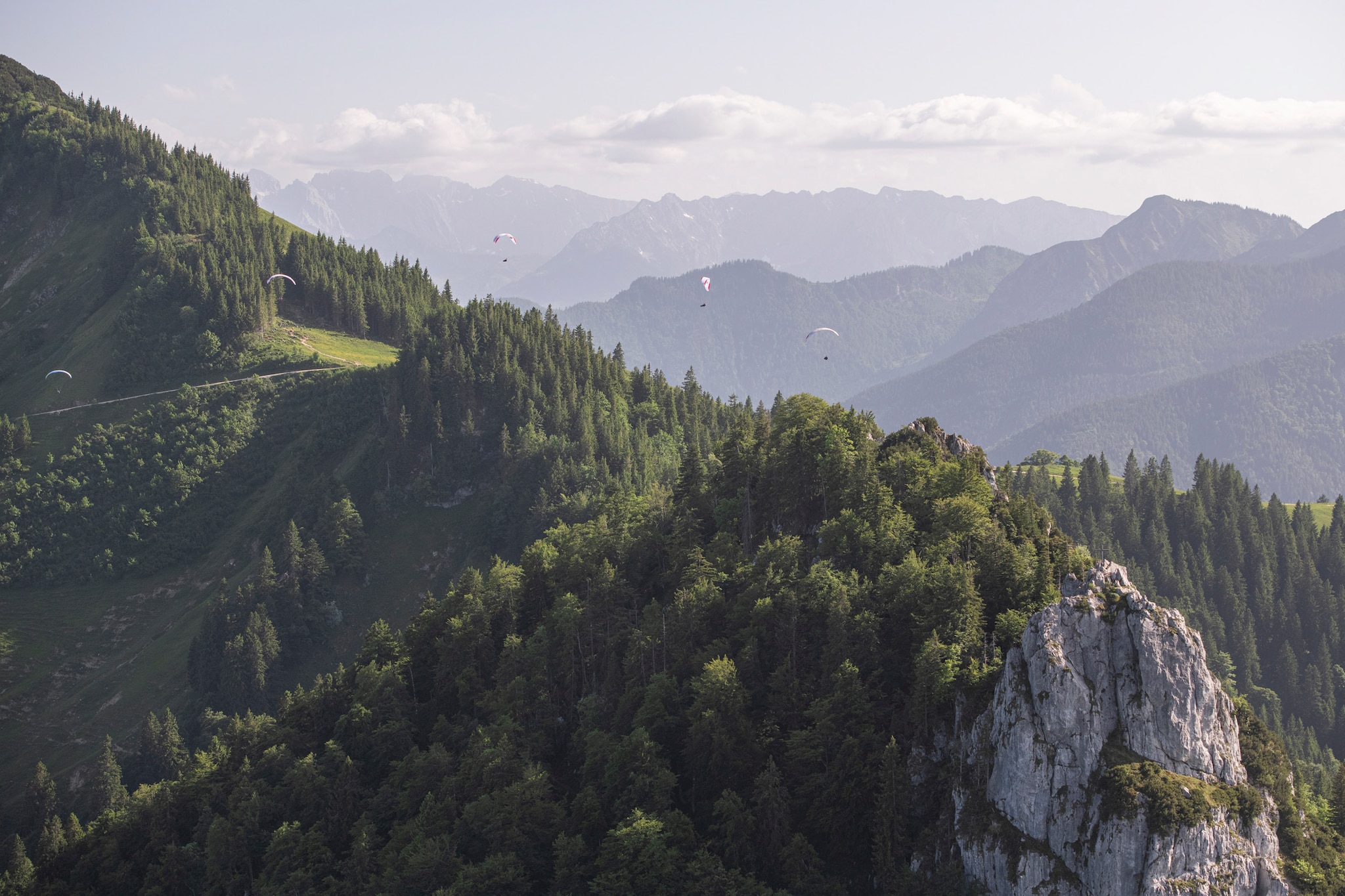 Chrigl Maurer (SUI1), Markus Anders (GER1), Paul Guschlbauer (AUT1) and Aaron Drogati (ITA1) race close to the mountain range Kampenwand prior to the Red Bull X-Alps, Germany on June 21, 2021.