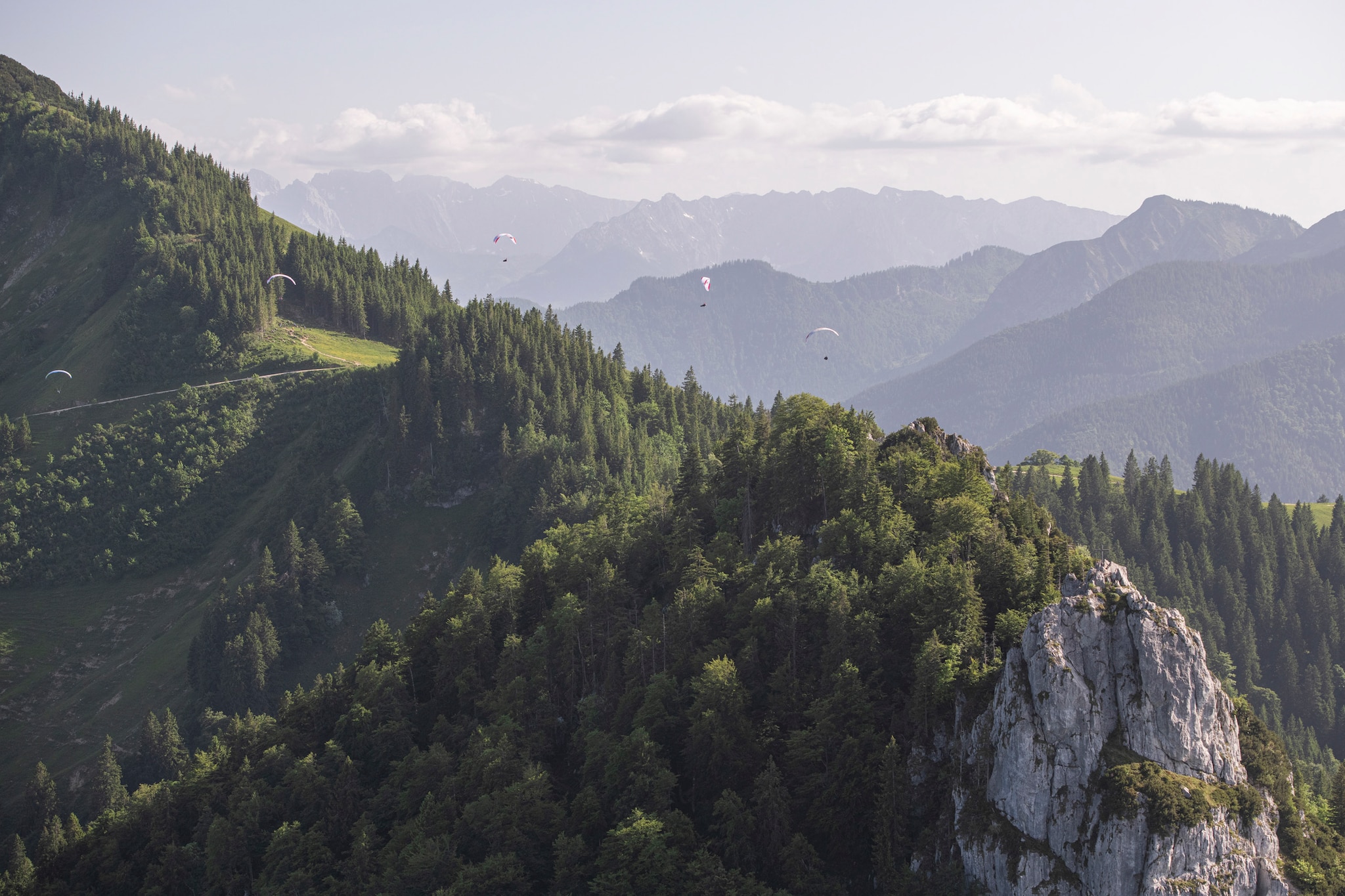 Chrigl Maurer (SUI1), Markus Anders (GER1), Paul Guschlbauer (AUT1) and  Aaron Drogati (ITA1) race close to the mountain range Kampenwand prior to the Red Bull X-Alps, Germany on June 21, 2021.