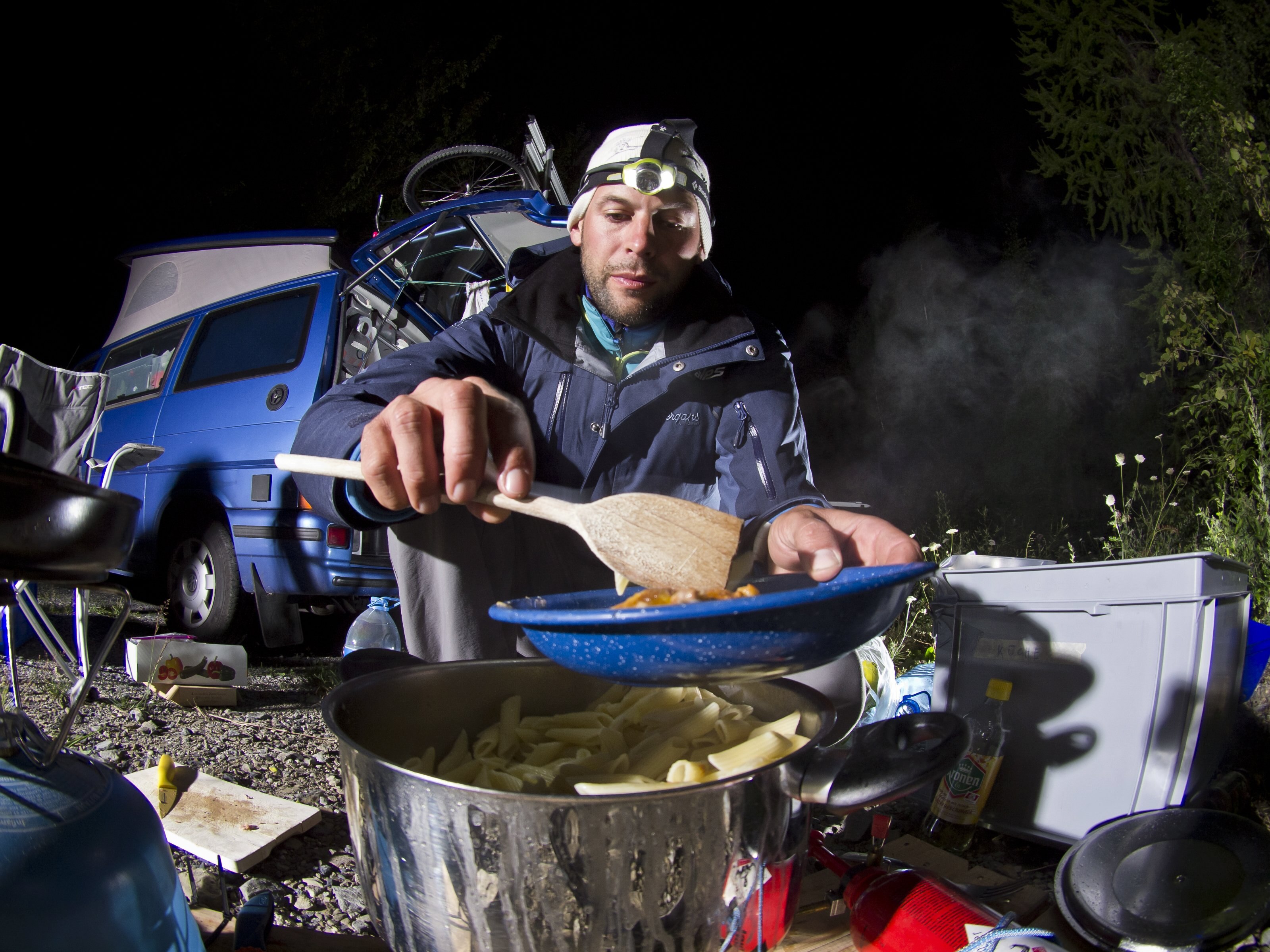 Christian Maurer's (SUI1) supporter Thomas makes dinner during the Red Bull X-Alps on July 25th, 2011 at Montricher - Albanne in France. // Vitek Ludvik/Red Bull Content Pool // SI201107260233 // Usage for editorial use only //