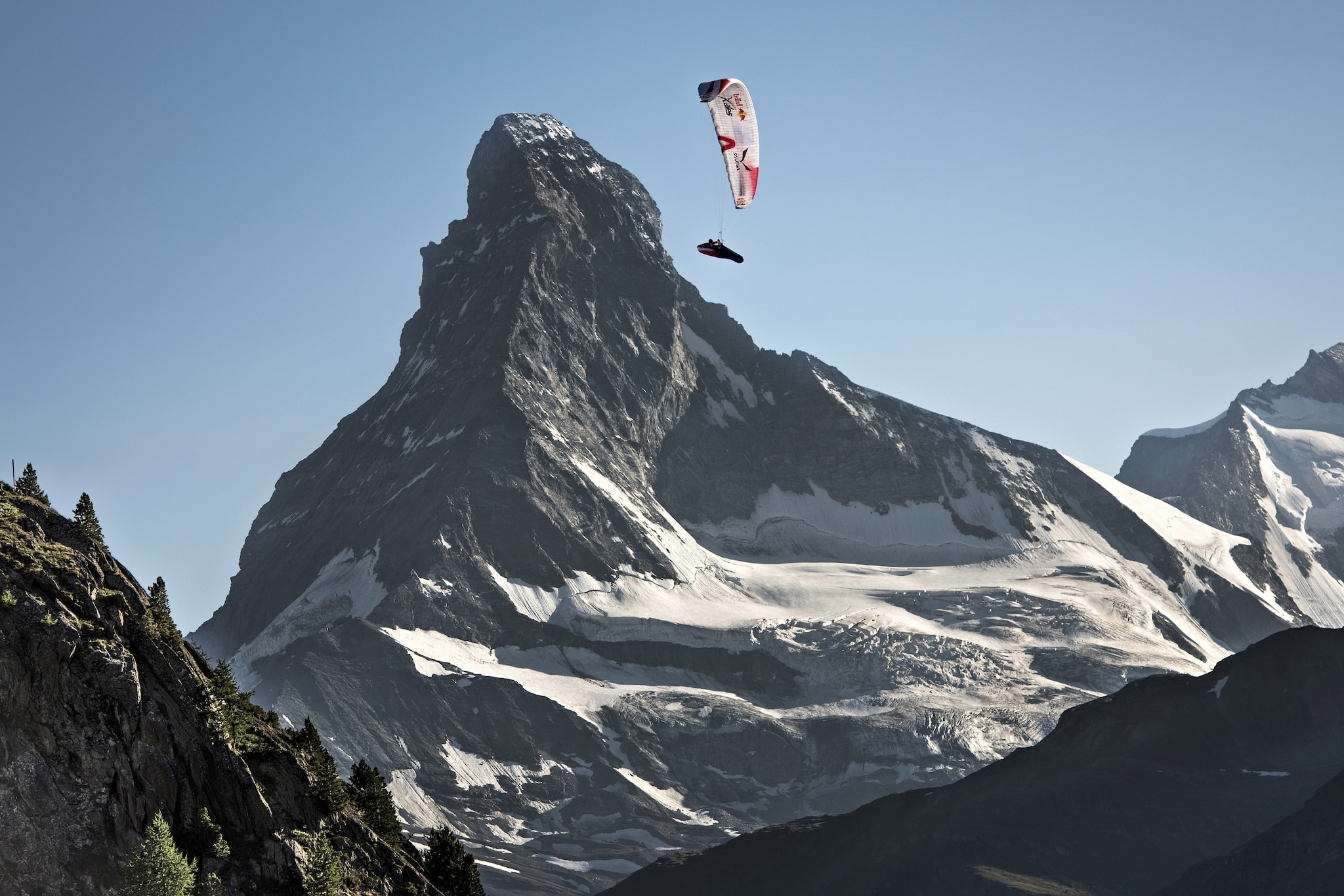 Paul Guschlbauer of Austria performs in front of the Matterhorn at the Red Bull X-Alps, Zermatt, Switzerland on July 10 2015.