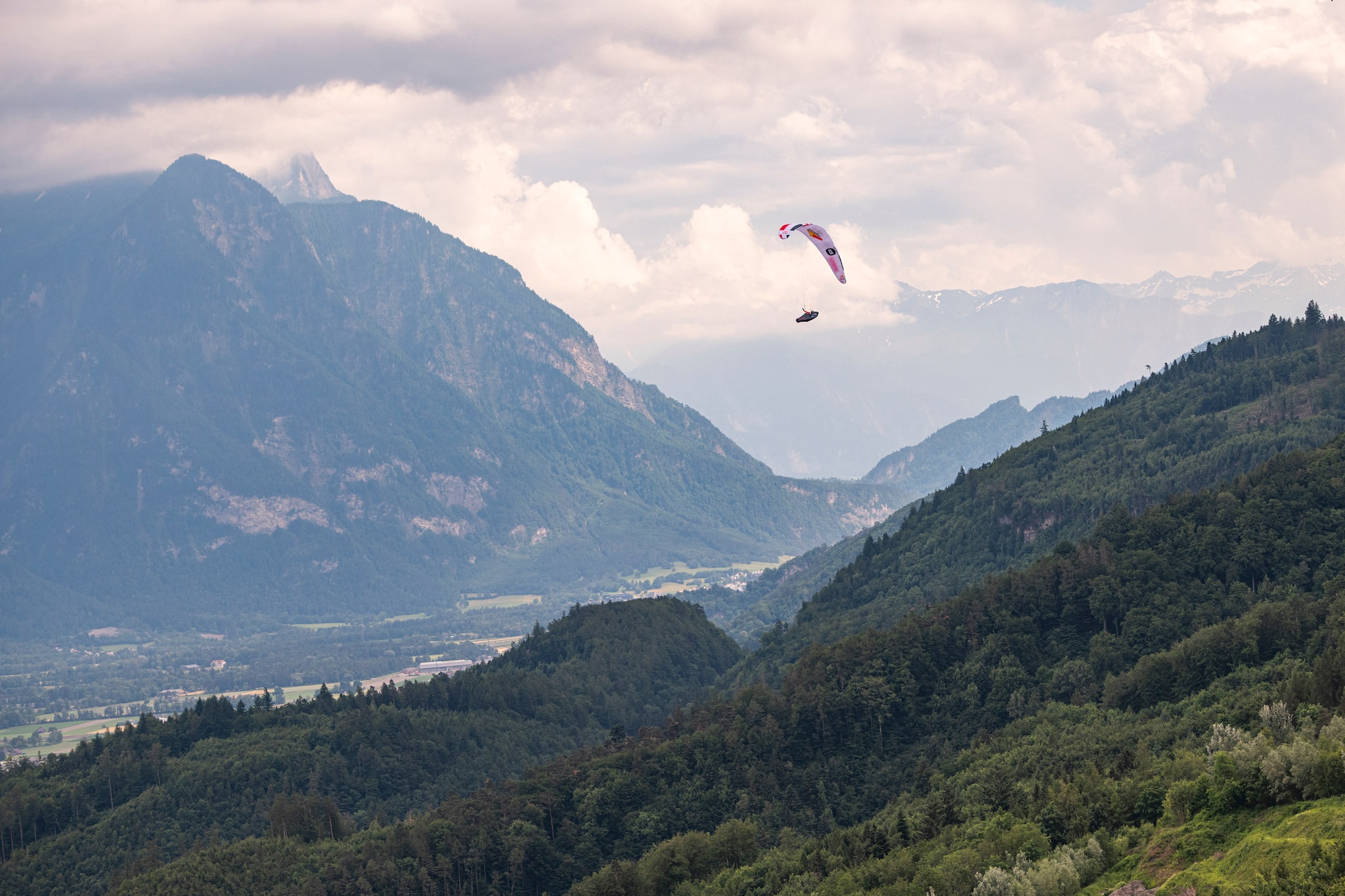 Simon Oberrauner (AUT2) performing during the Red Bull X-Alps above the Rheintal / Liechtenstein on 23-June-2021. In this endurance adventure race athletes from 18 nations have to fly with paragliders or hike from Salzburg along the alps towards France, around the Mont Blanc back to Salzburg.